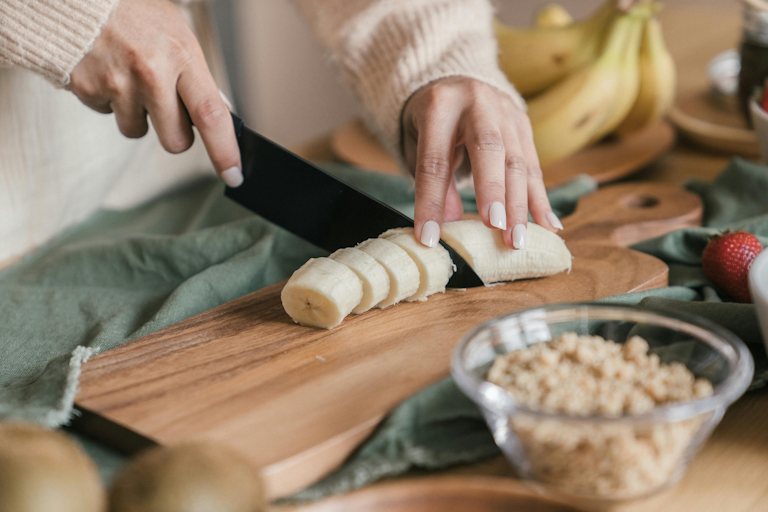 Woman cutting a banana