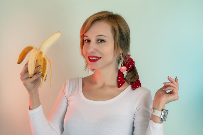 woman keeping banana in hand